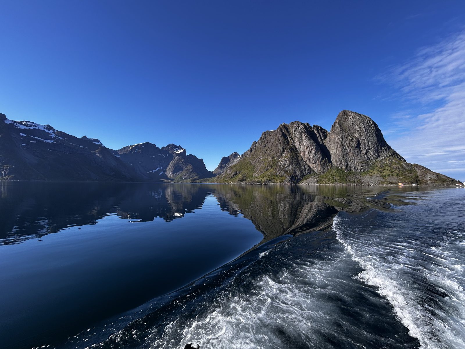 Reine’s peaks doubled in the fjord on a calm May morning