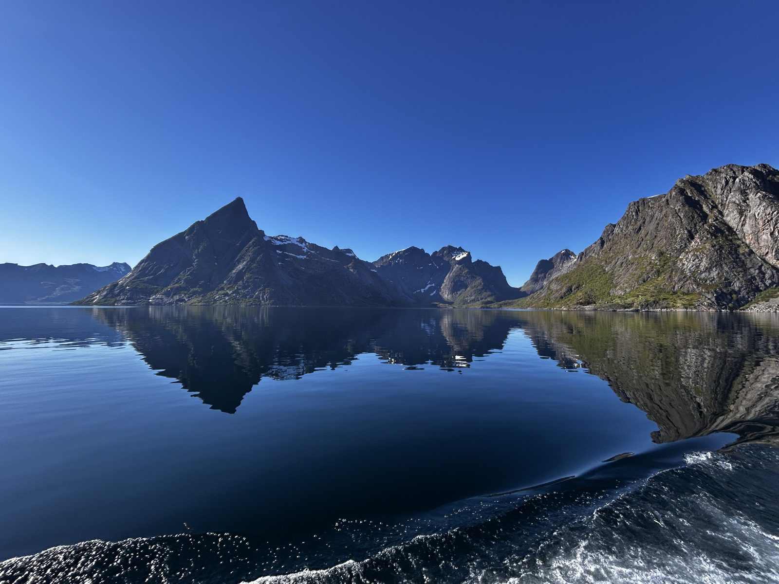 Reine mirrored in the fjord.