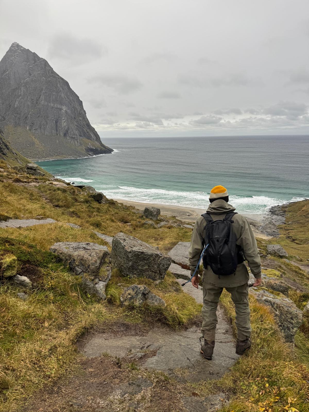 One of the hosts on the descent path looking down over Kvalvika bay