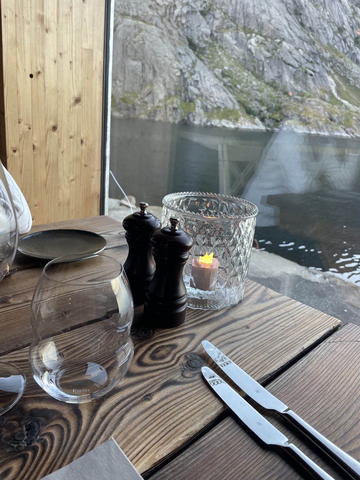 A candlelit place setting by the window in Nusfjord