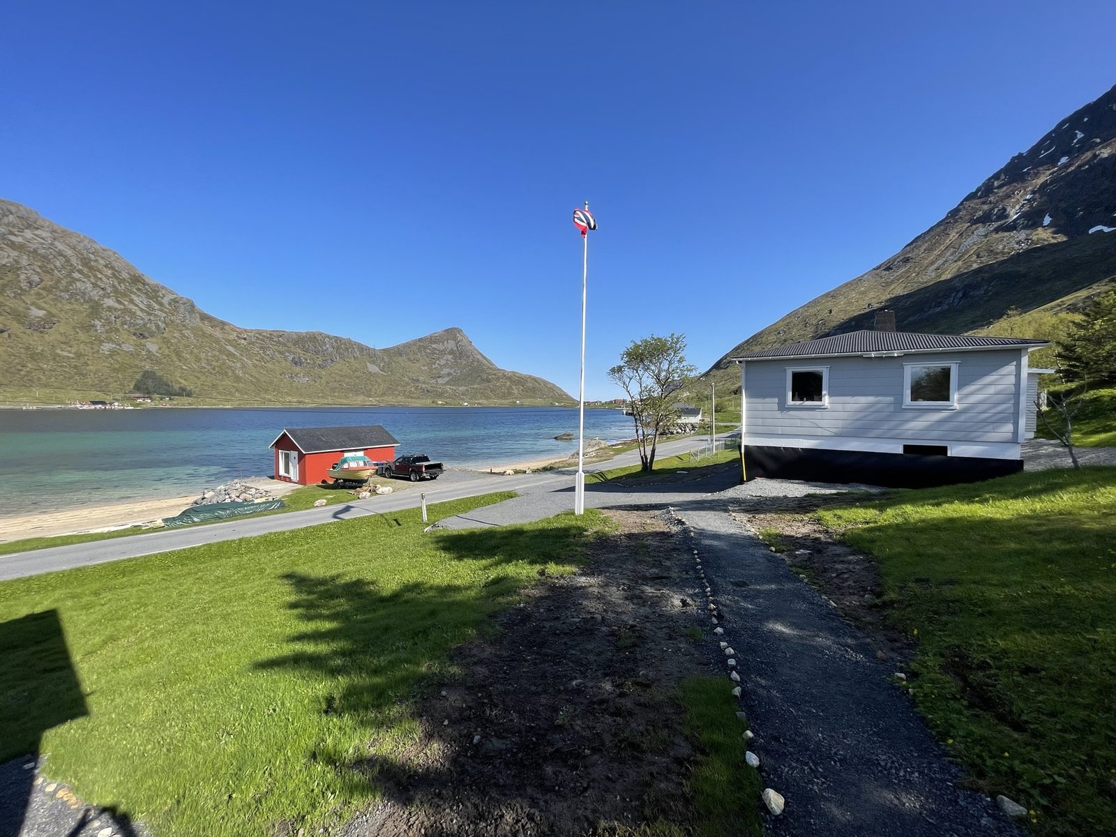The lawn between the house and the beach, looking out the fjord (IMG_1397).