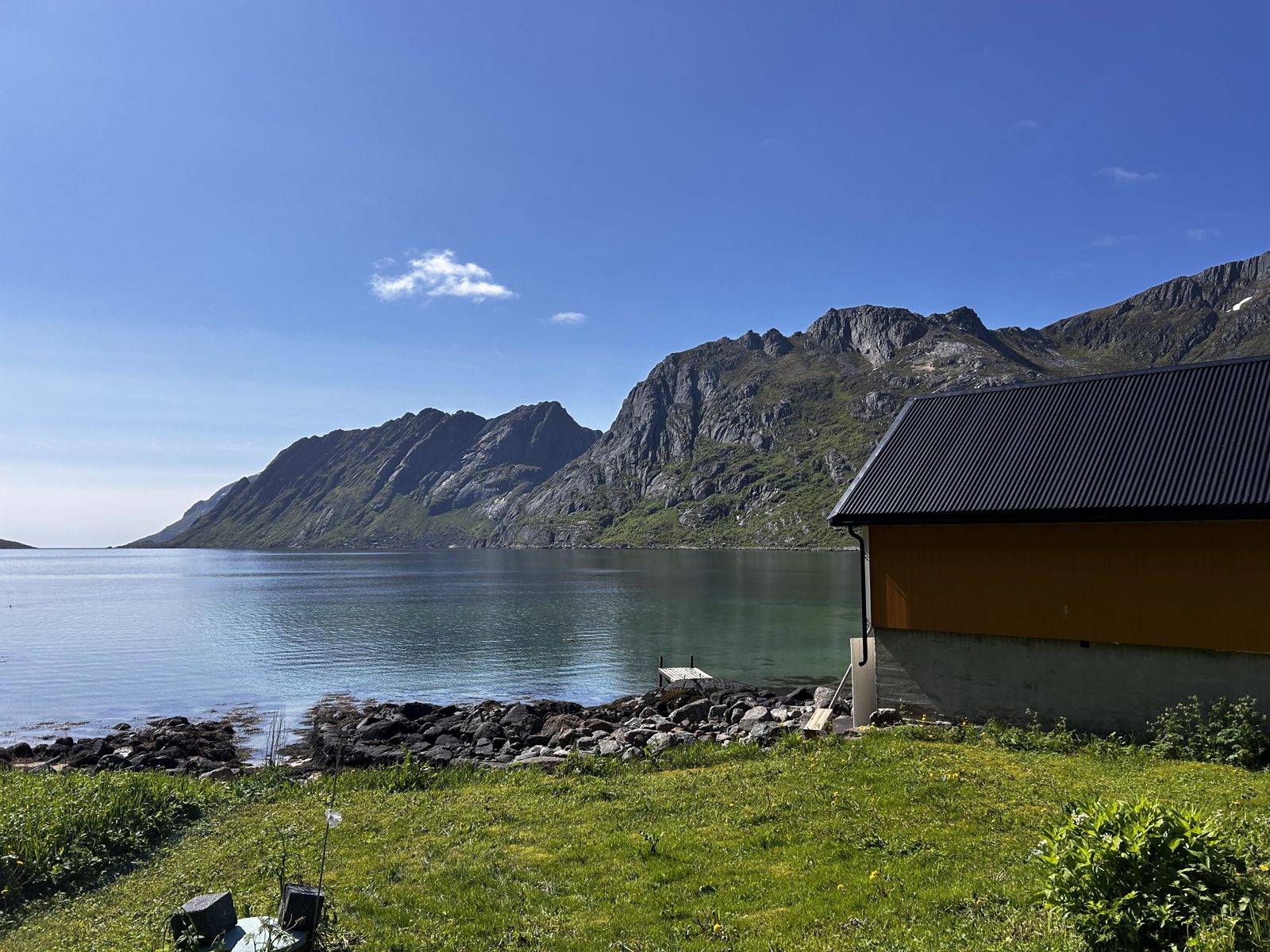 A yellow house on the shore of Skjelfjorden