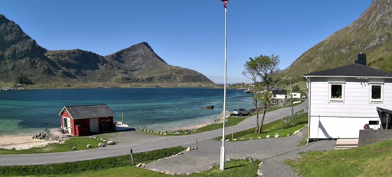 The same view in sun, blue sky over a blue fjord, 21 May.