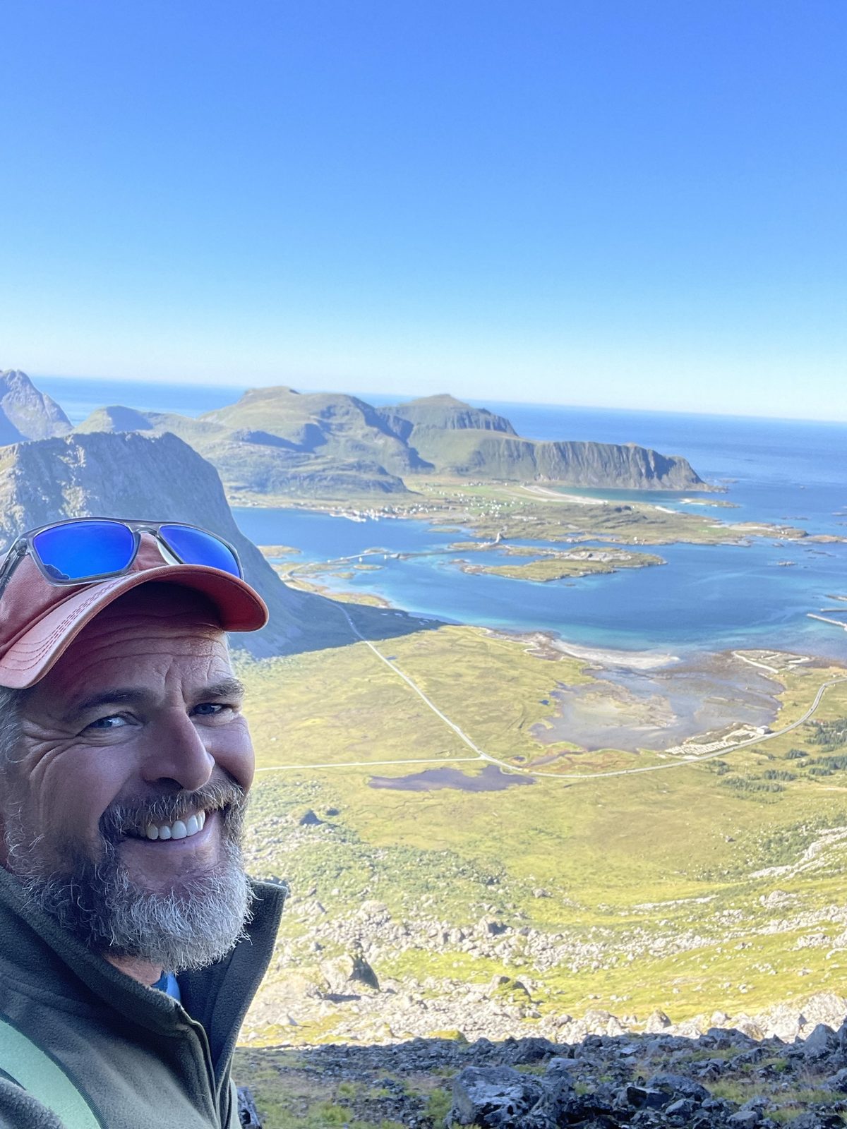 Vegard at the top on a summer hike, looking over to Fredvang (IMG_1753).