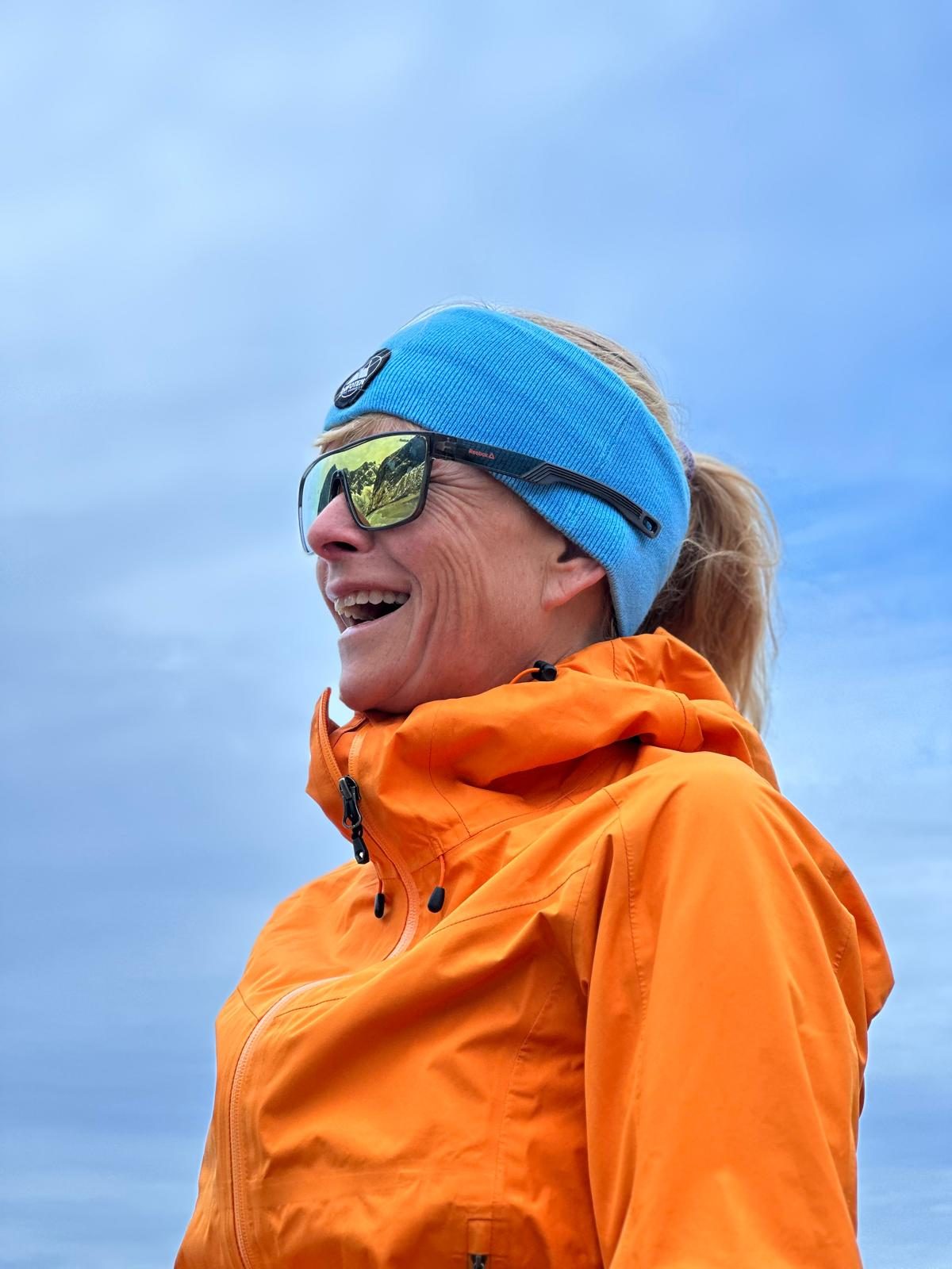 Susanne laughing, out on a trail.