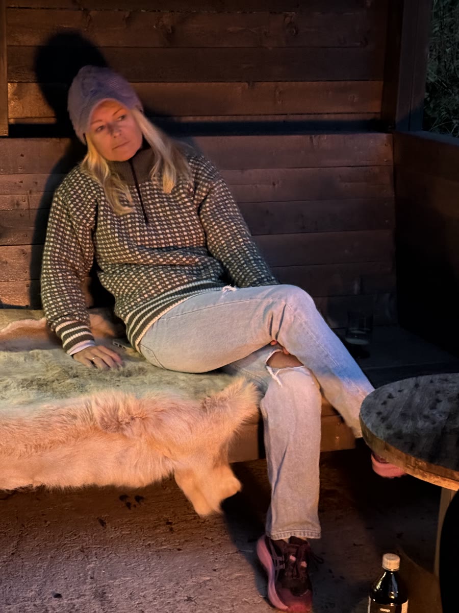 Susanne resting on a sheepskin bench in warm light (IMG_0944).