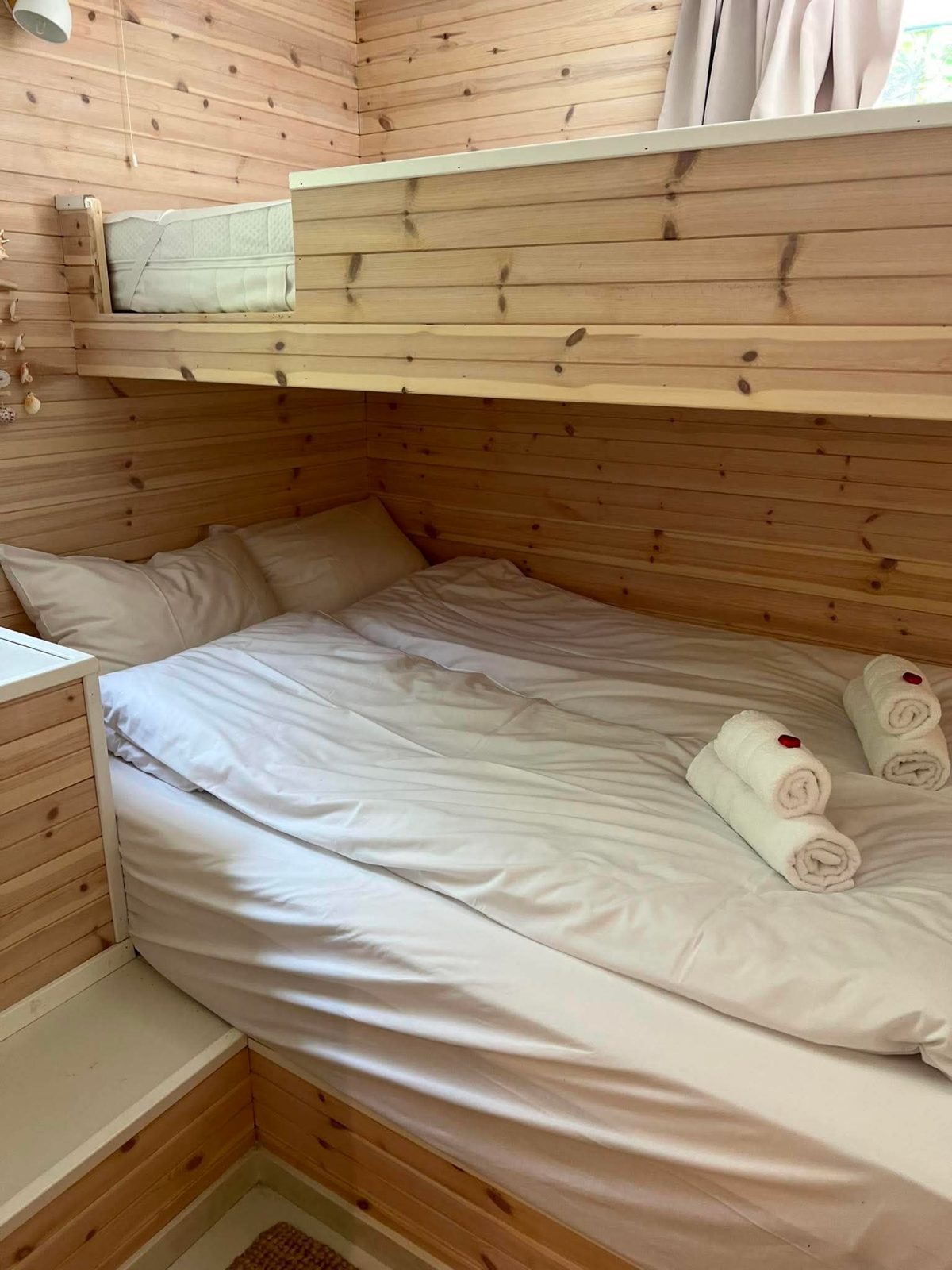 Bedroom with a queen bed and panelled wall. Photo 3 of 7.