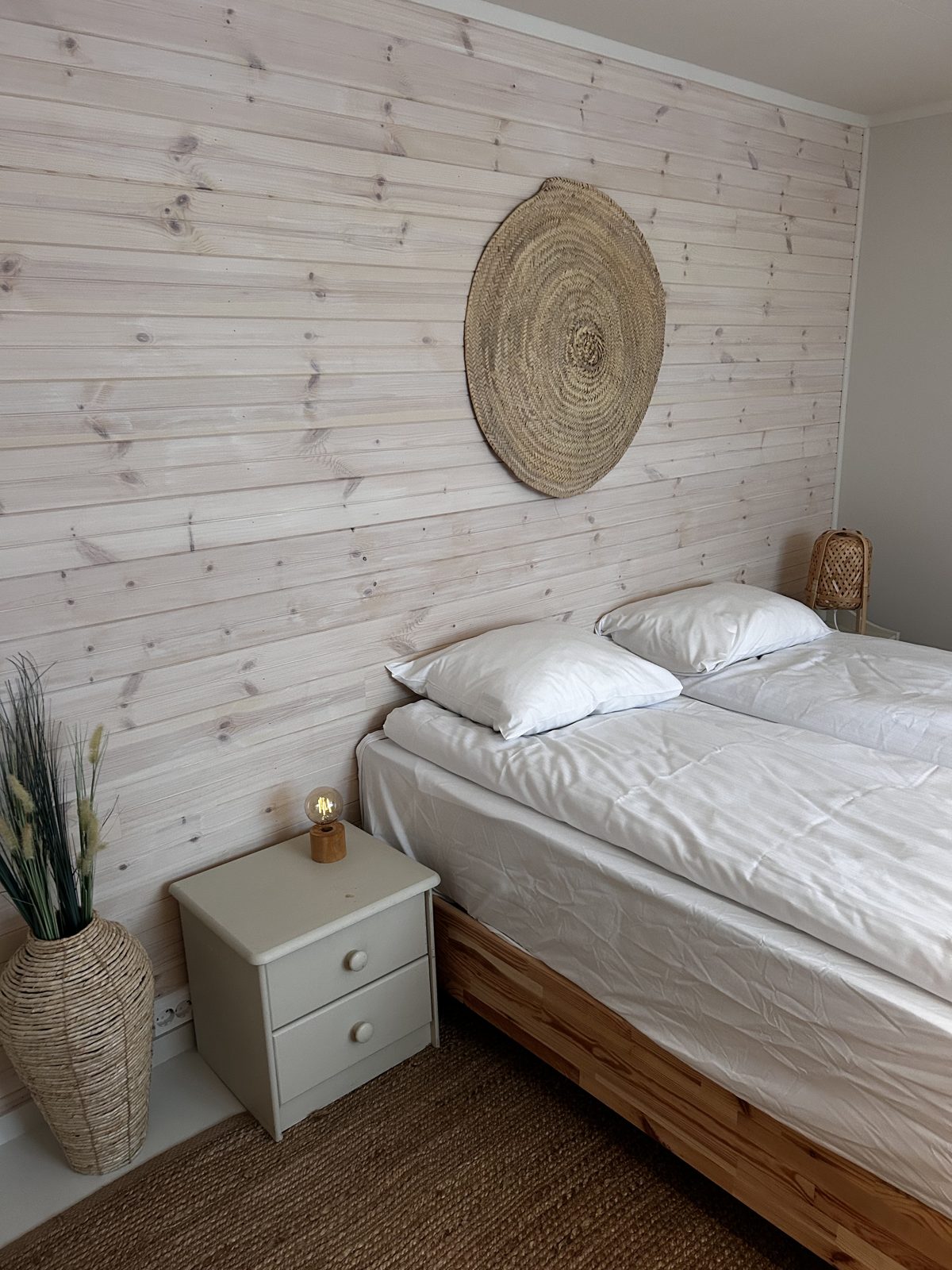 Bedroom with a queen bed and panelled wall. Photo 4 of 7.