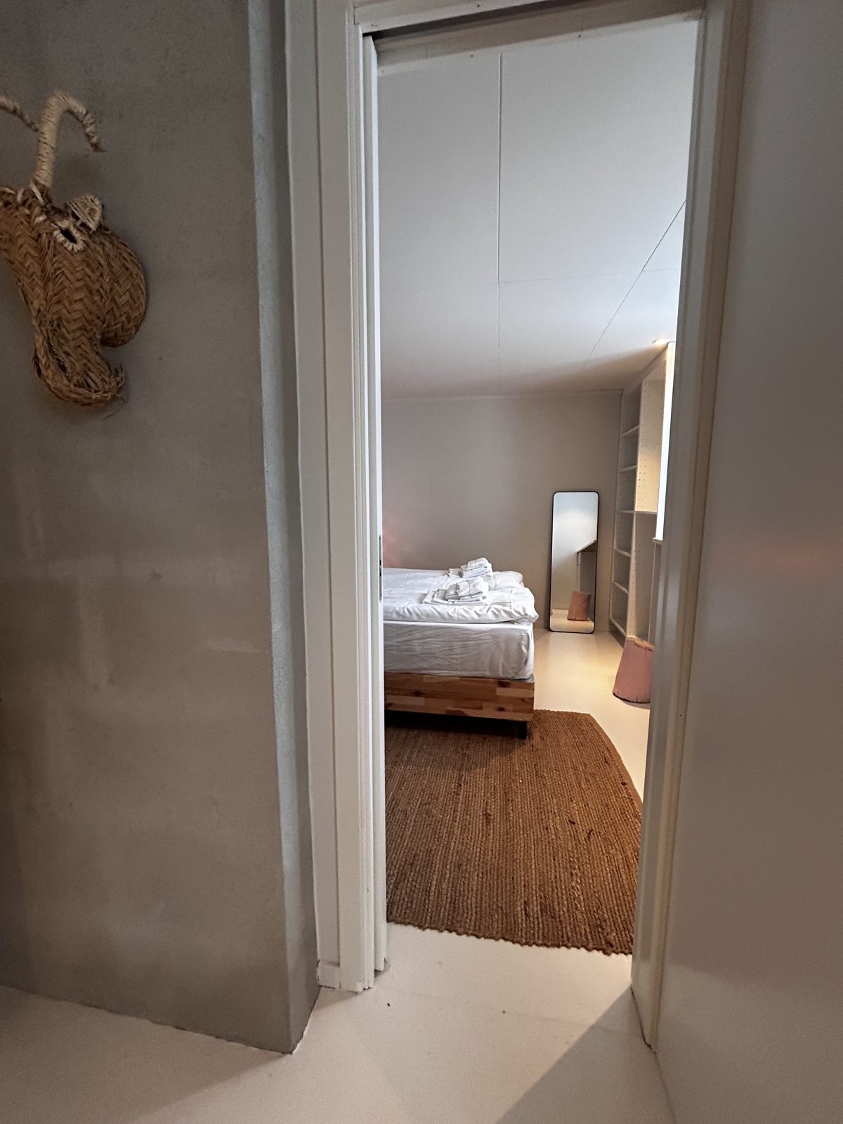 Bedroom with a queen bed and panelled wall. Photo 7 of 7.