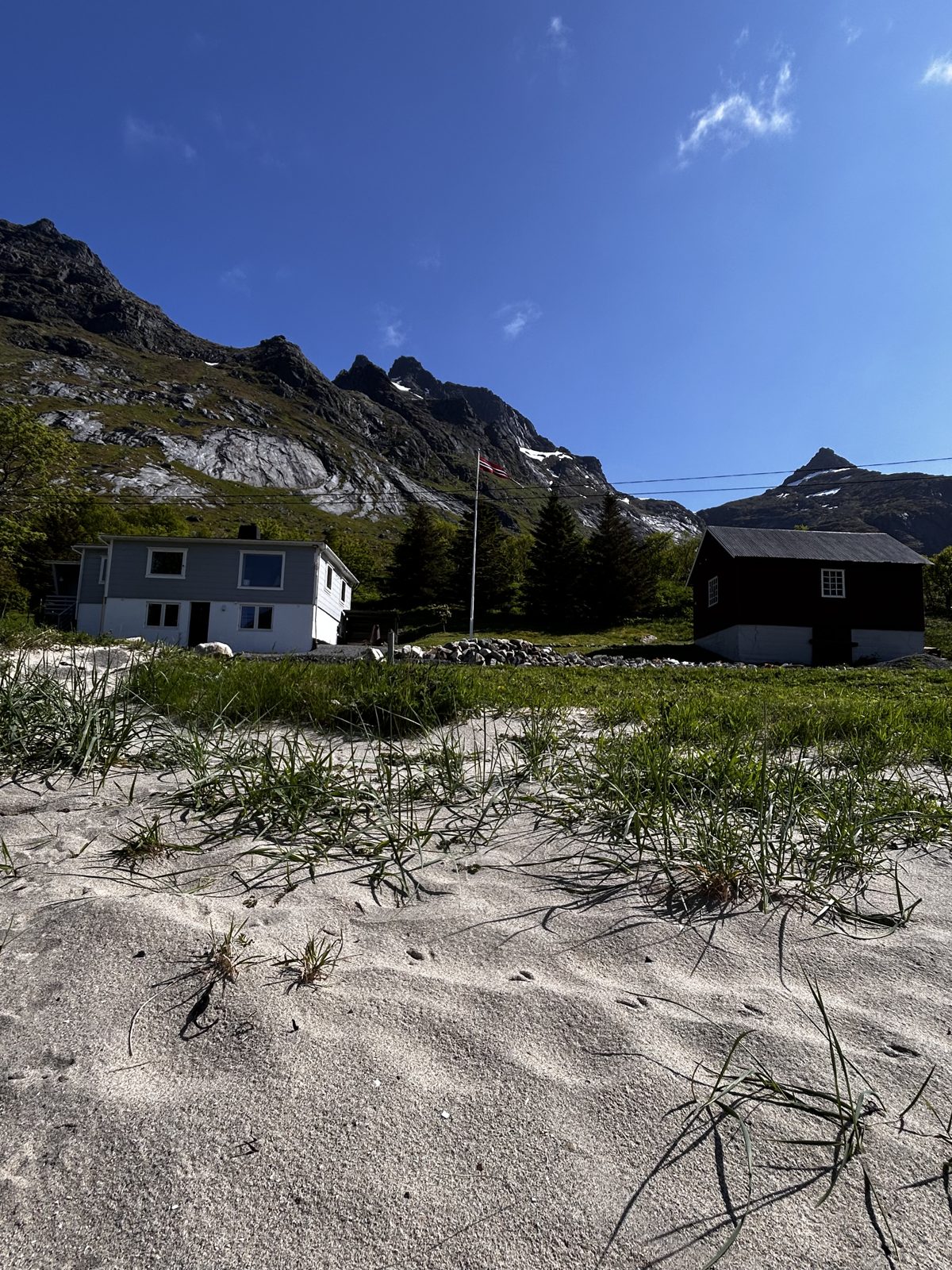 The main house and the old barn seen from the beach.