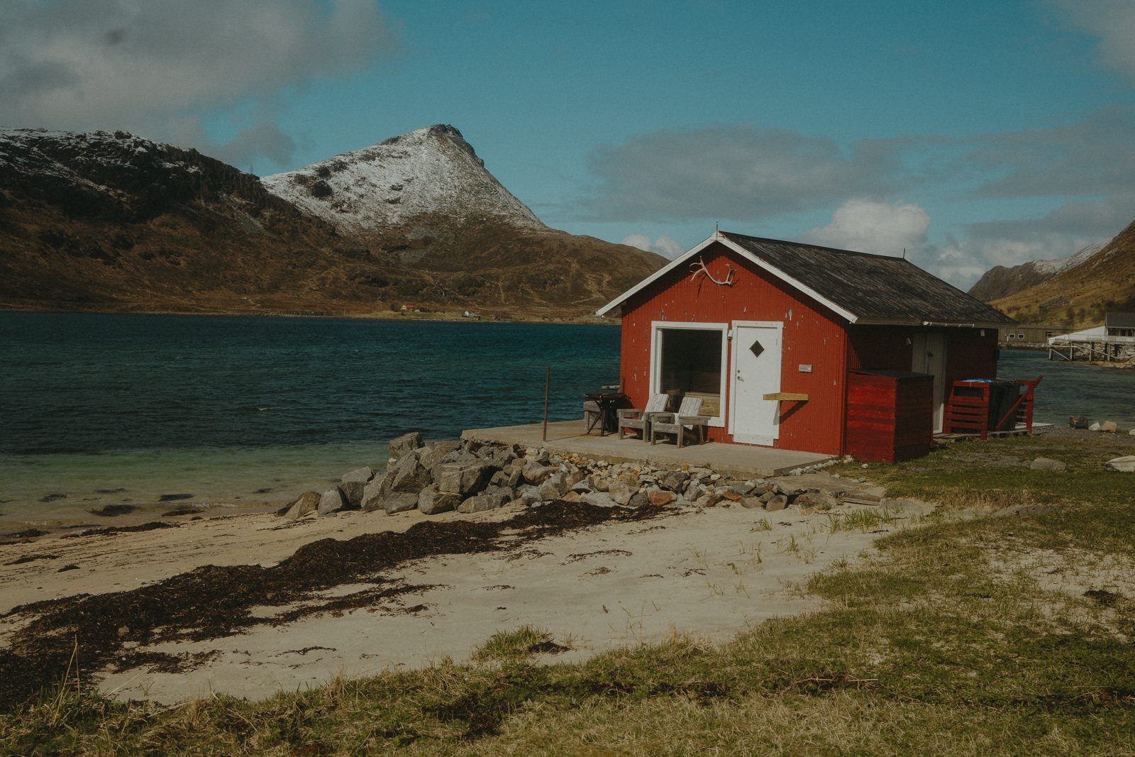 The red sauna house on the shore in summer.
